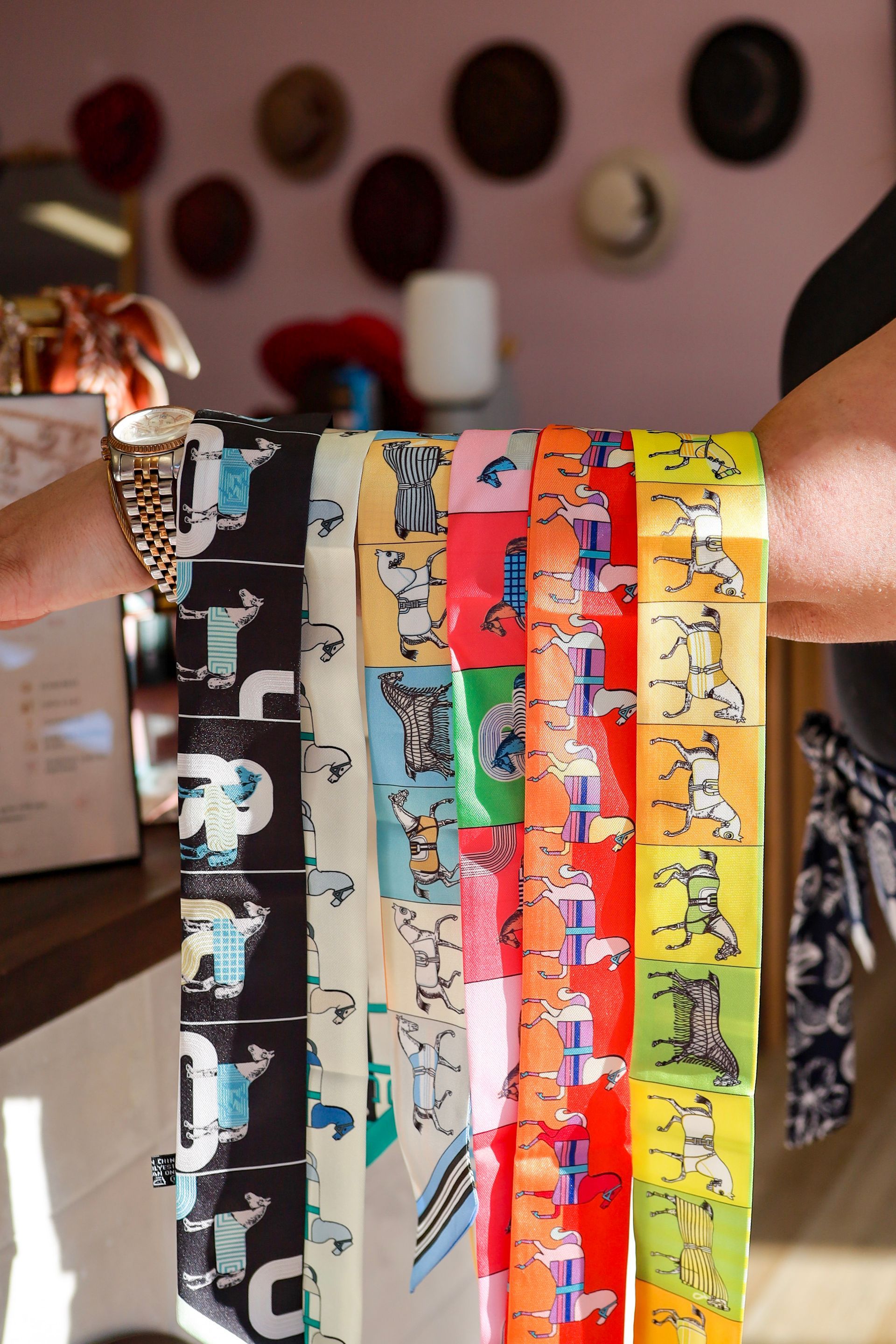 Rows of colorful patterned neckties displayed hanging indoors