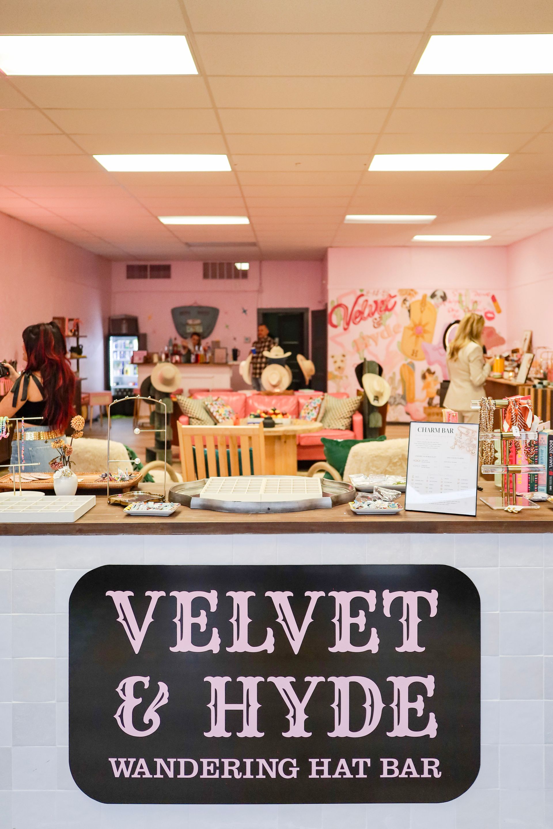 Velvet & Hyde wandering gift bar booth with pink decor and displayed merchandise
