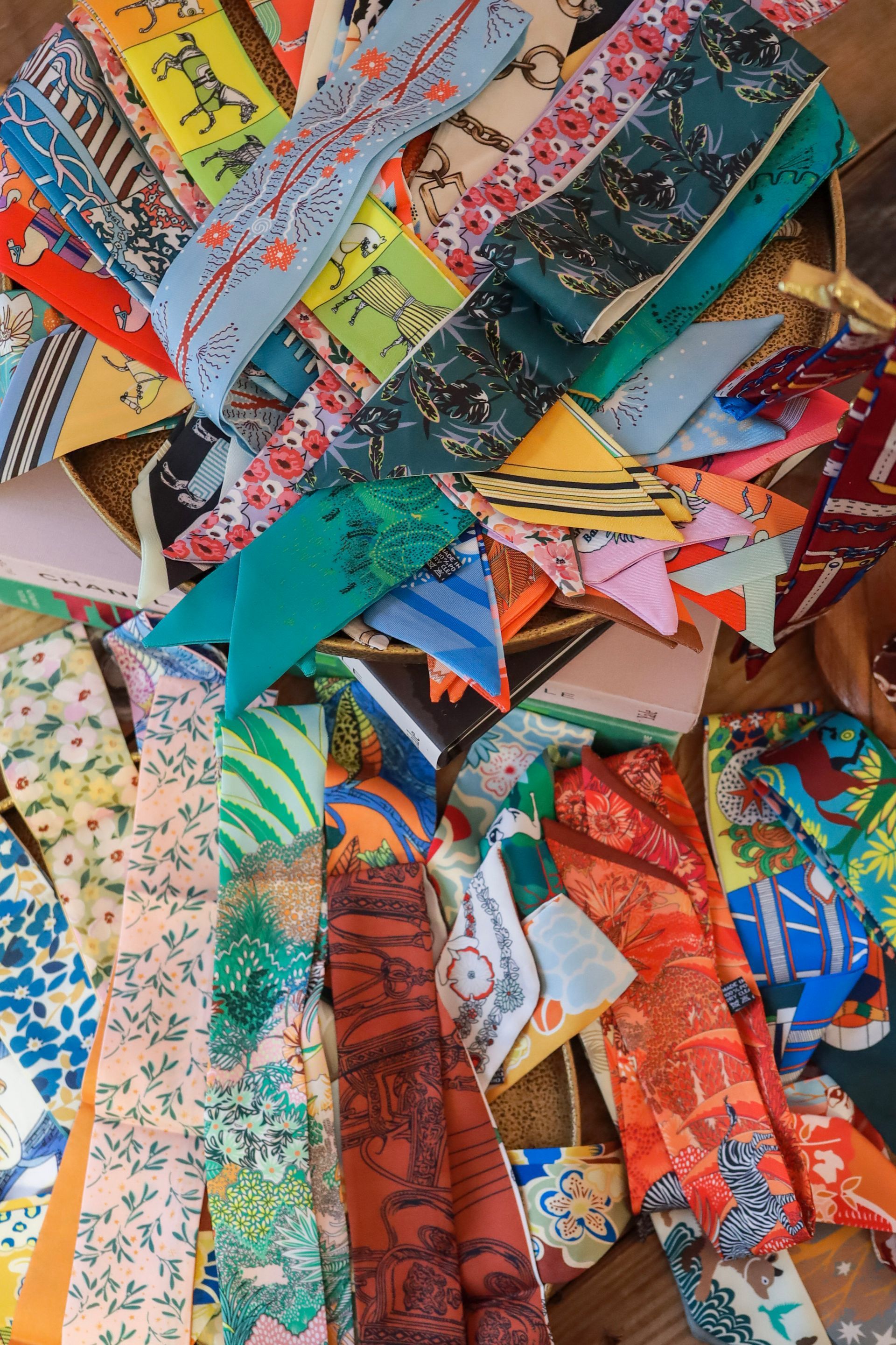 Colorful patchwork fabric scraps and quilt pieces layered in a vibrant, abstract pile