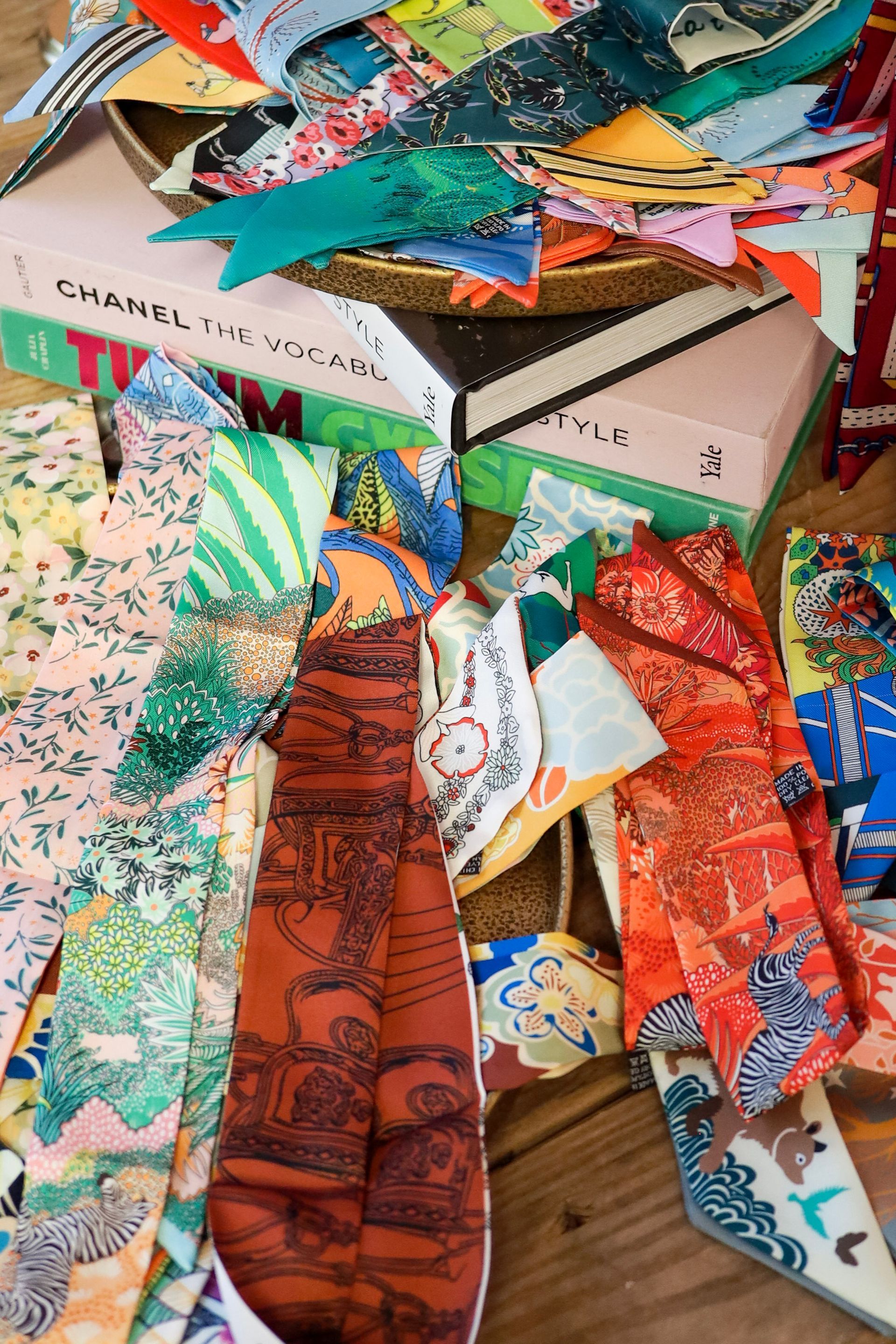 Colorful patterned fabric scraps and handmade items piled in a cluttered display