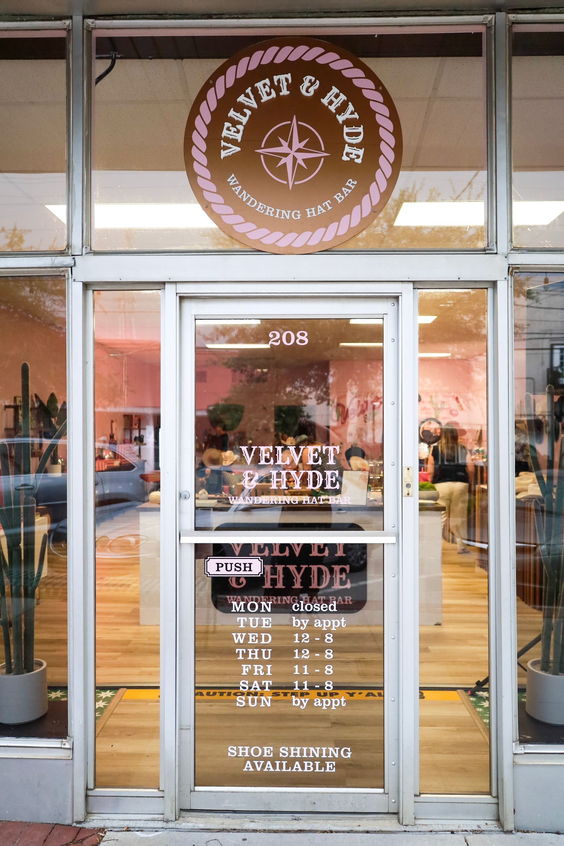 Glass storefront of Velvet Hyde salon with gold signage and entrance doors
