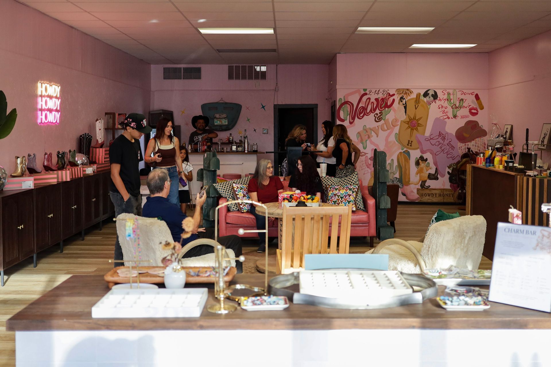 Pink party room with buffet tables, decorations, and several people gathered inside