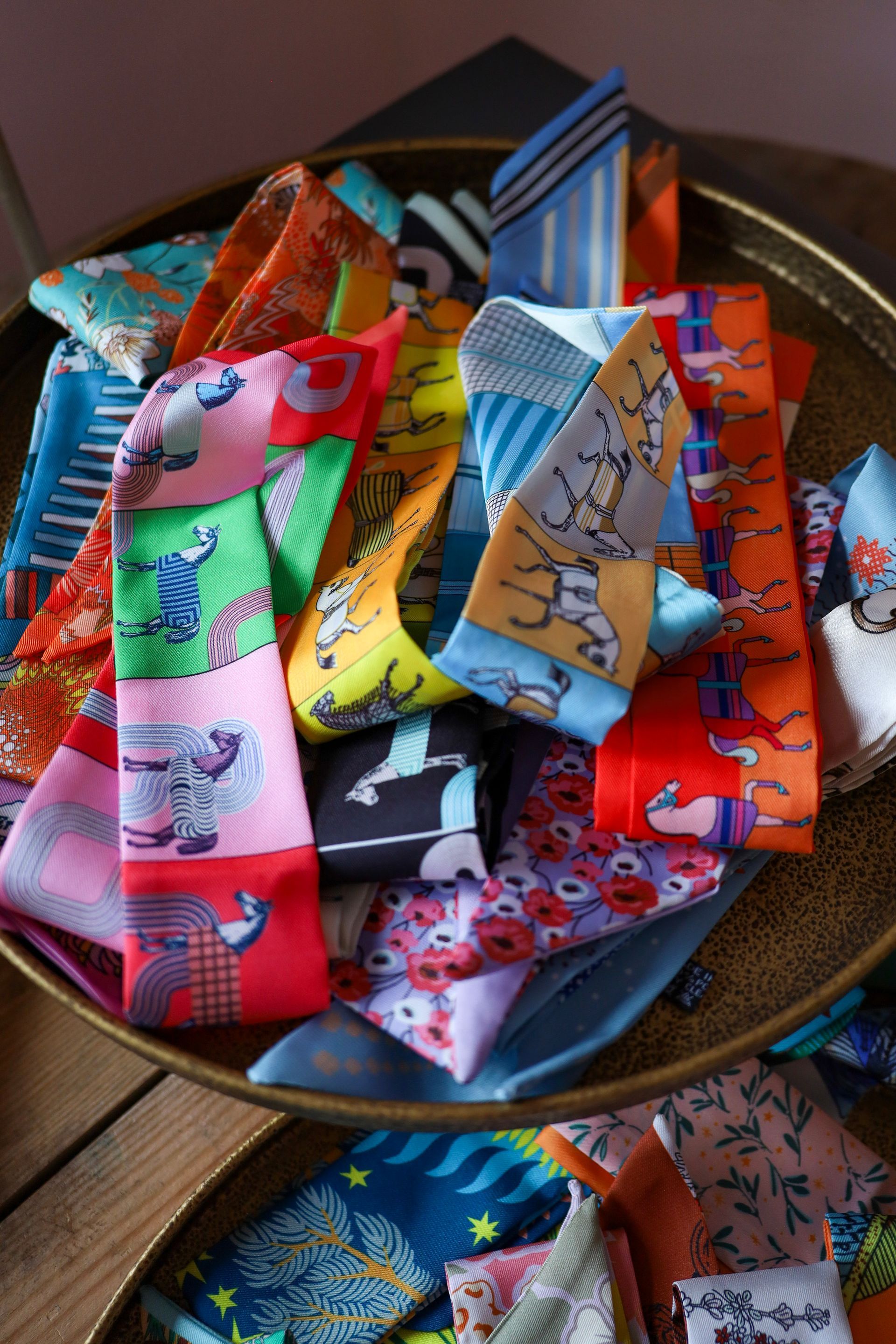 Colorful patterned fabric strips in a bowl on a wooden surface
