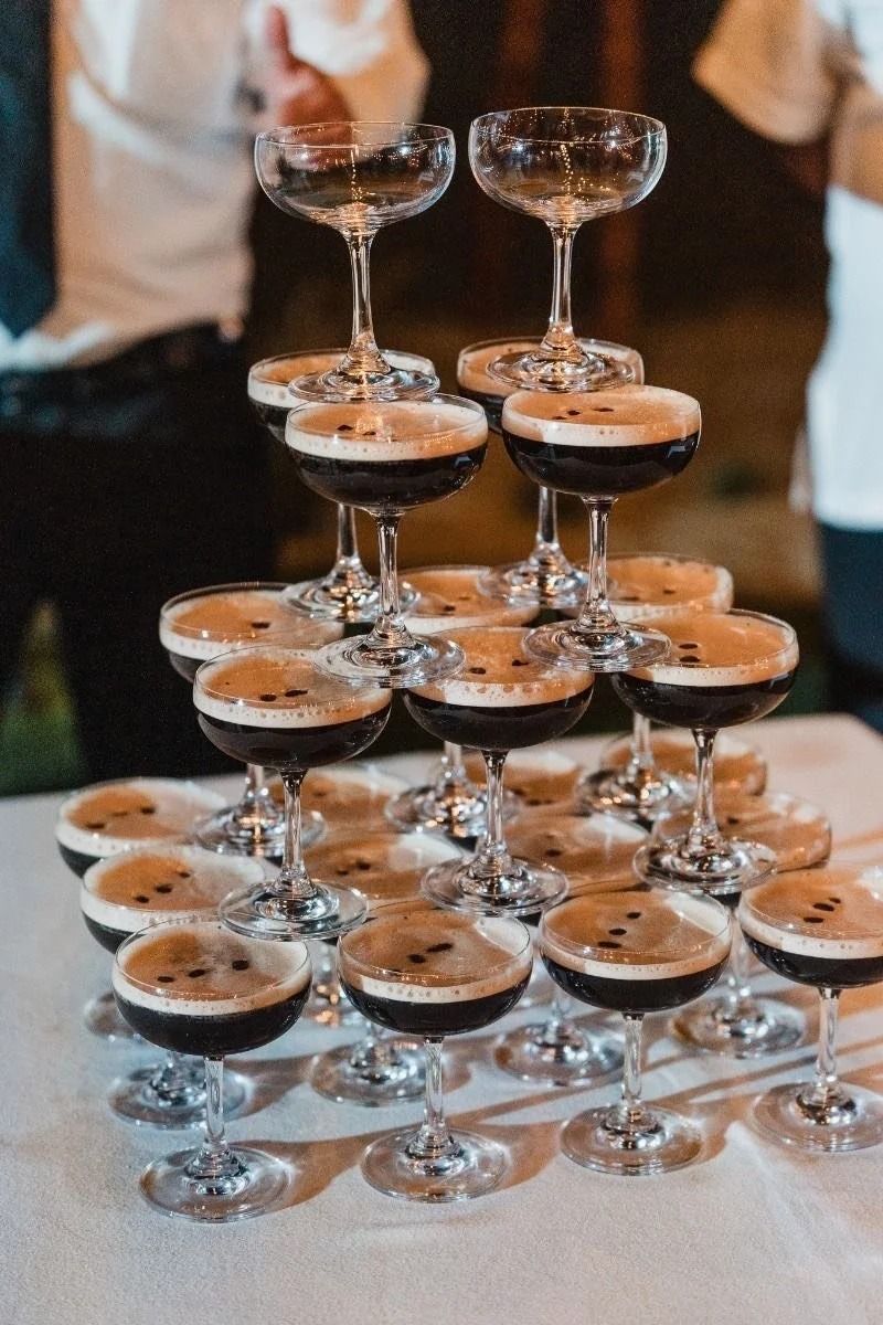 Tiered display of chocolate dessert shooters in stemmed glasses at a banquet table