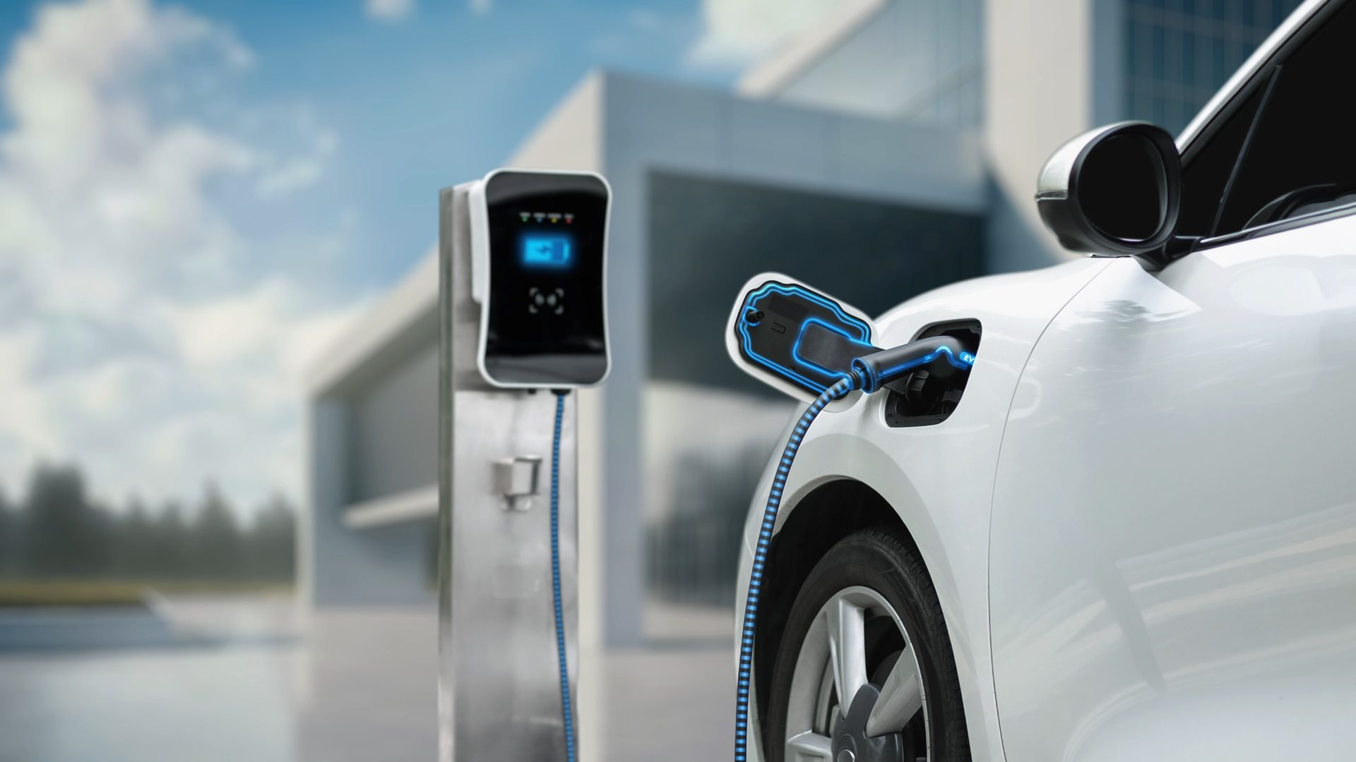 A white electric car is being charged at a charging station.