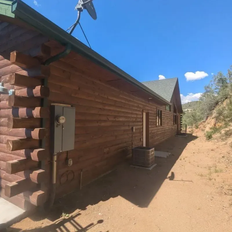 A log cabin with a satellite dish on the roof
