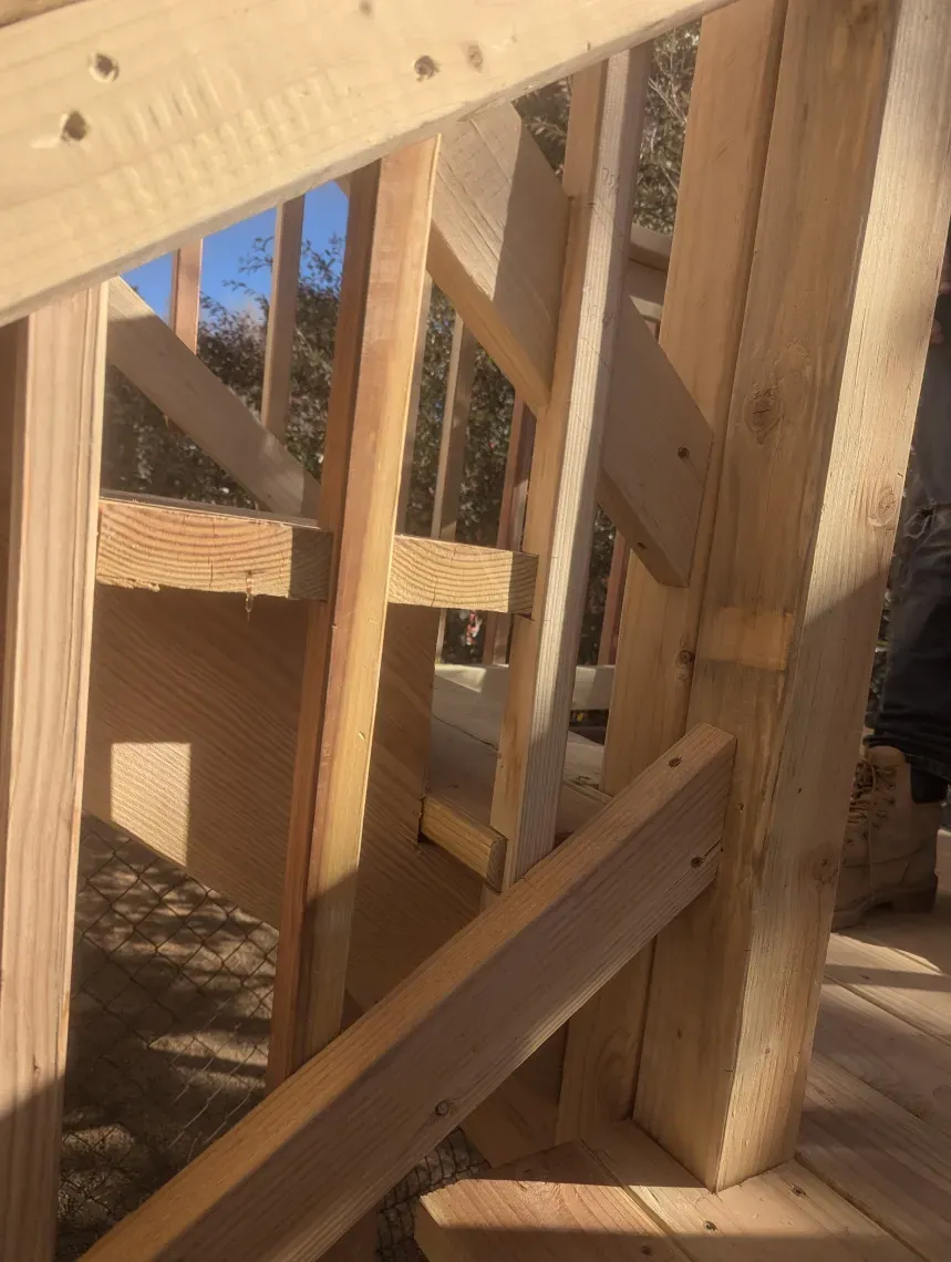 A close up of a wooden staircase with a railing