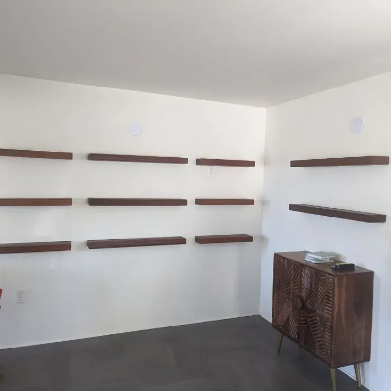 A room with wooden shelves and a wooden cabinet