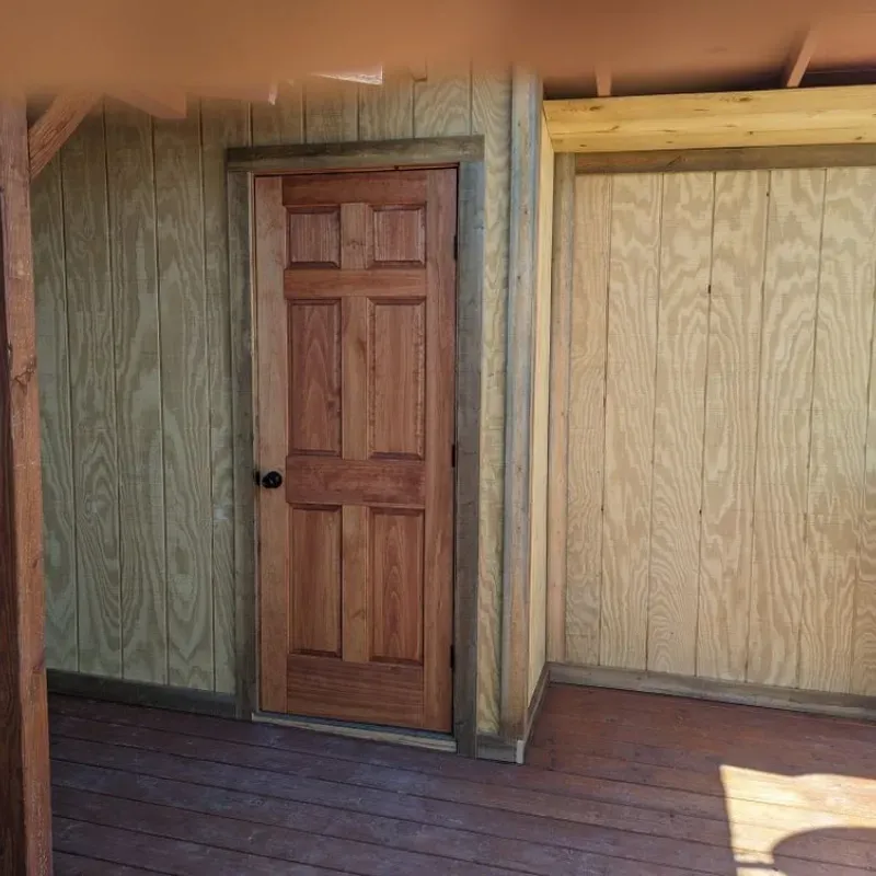 A wooden door with a wooden wall behind it