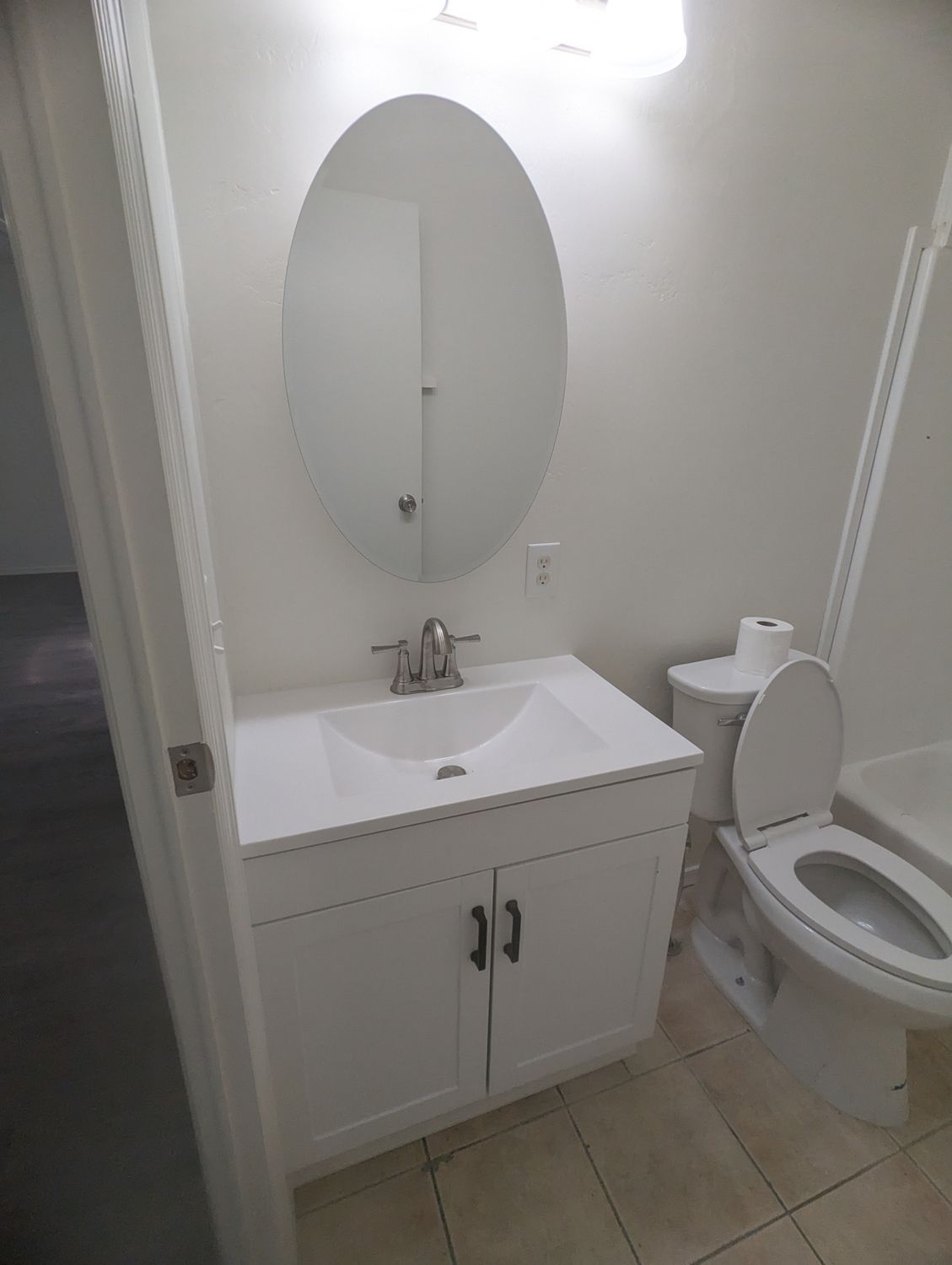 A bathroom with a sink , toilet and mirror.