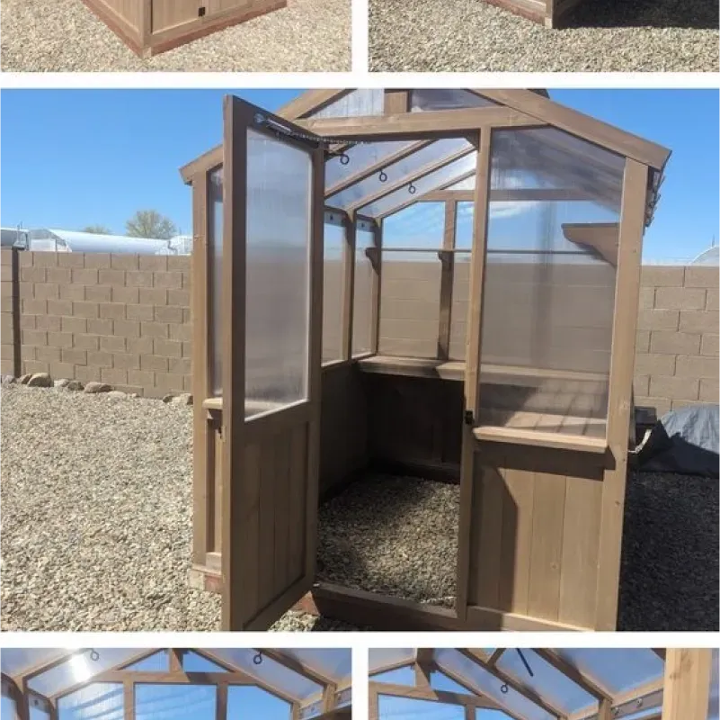 A wooden greenhouse with a clear plastic roof