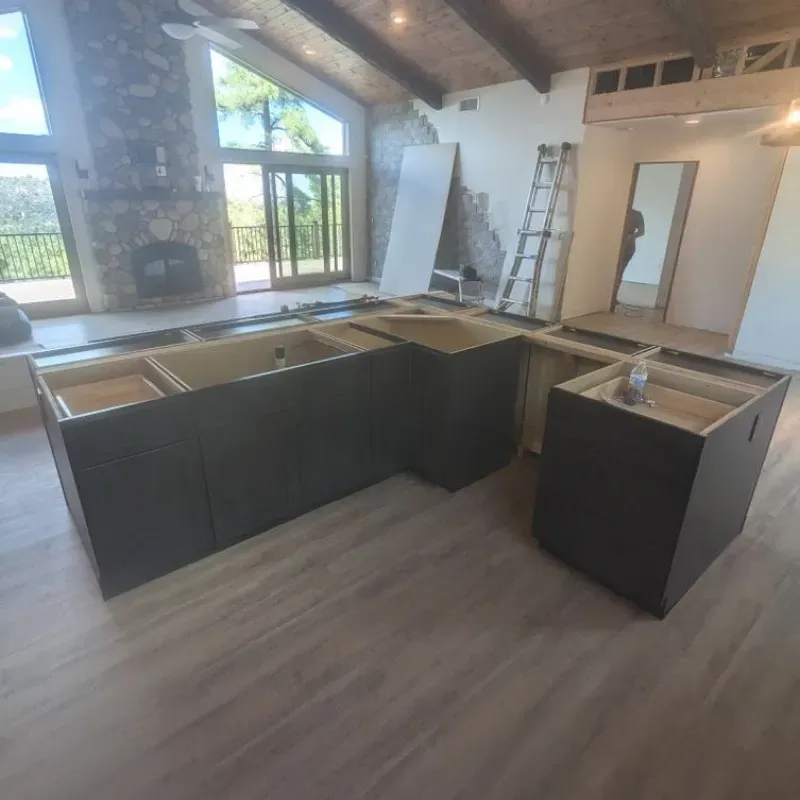 A kitchen with a lot of cabinets and a fireplace