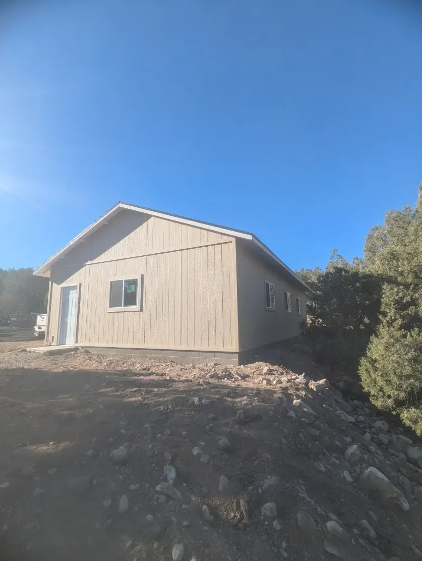 A small house with a blue sky in the background
