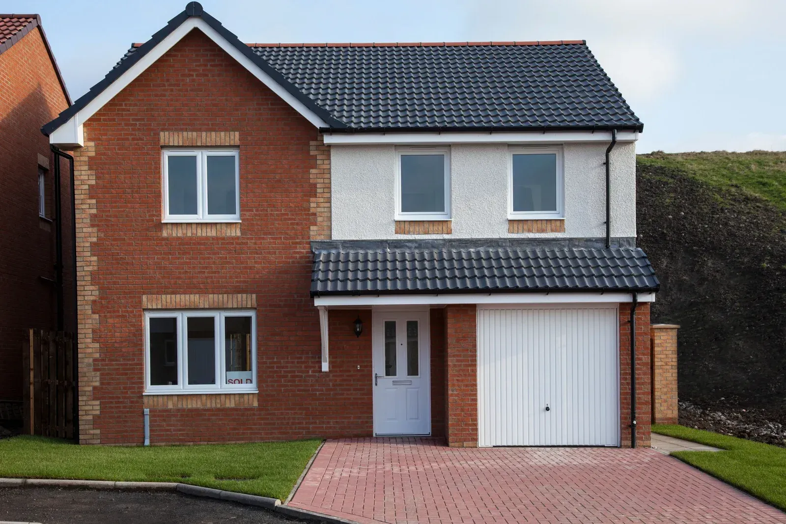 A large brick house with a white garage door
