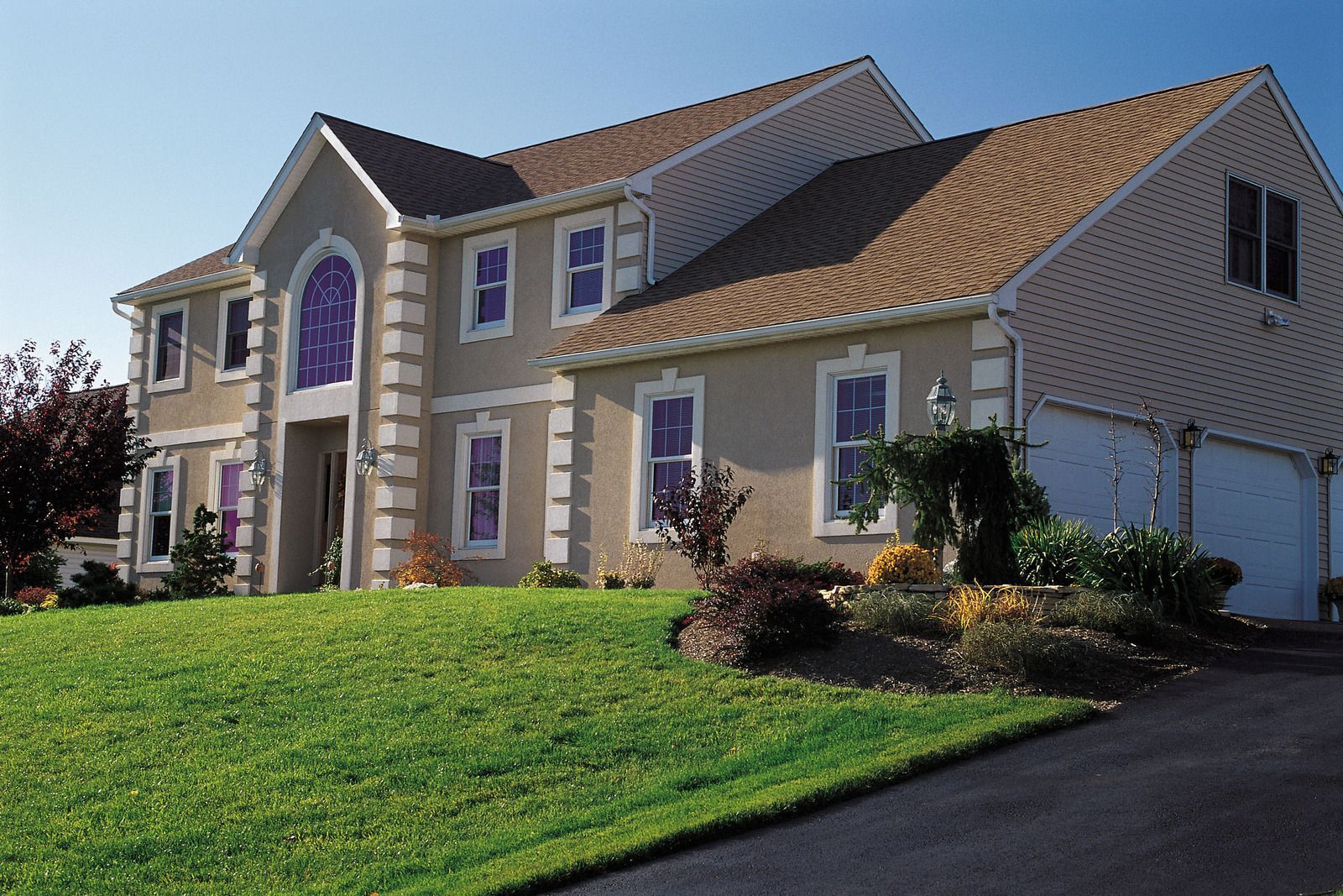 A large house with a lush green lawn in front of it