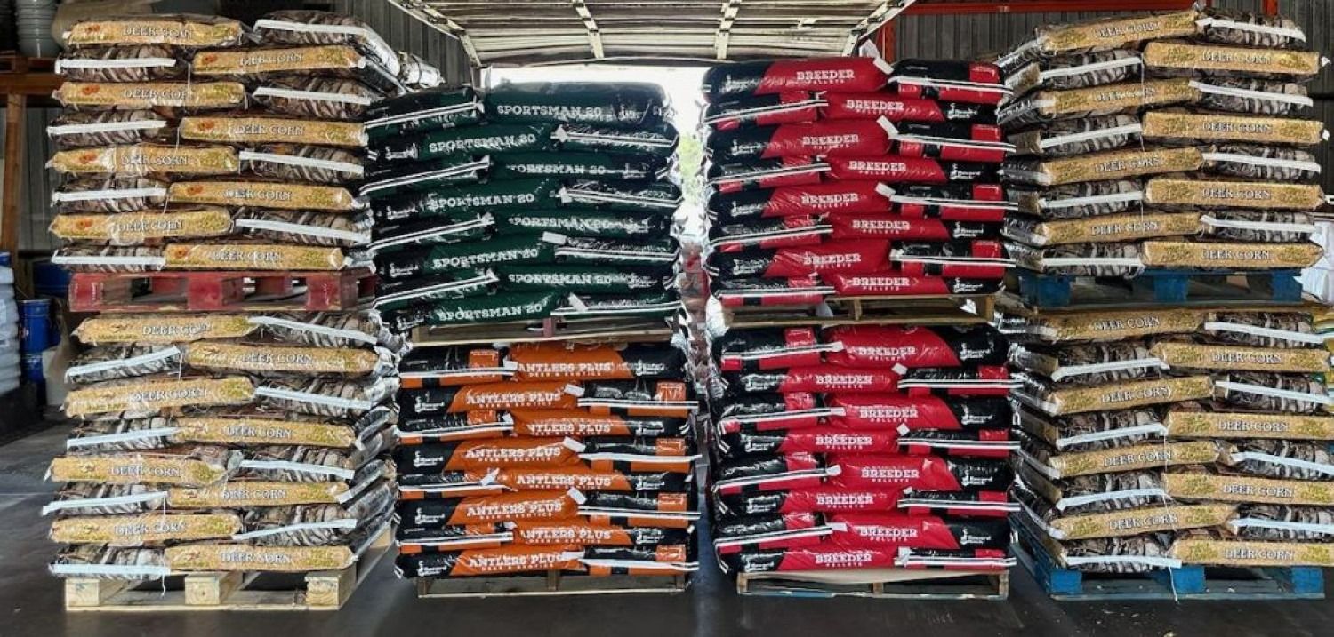 Stacks of colorful packaged goods arranged on warehouse shelves, including red, green, yellow, and orange bags.