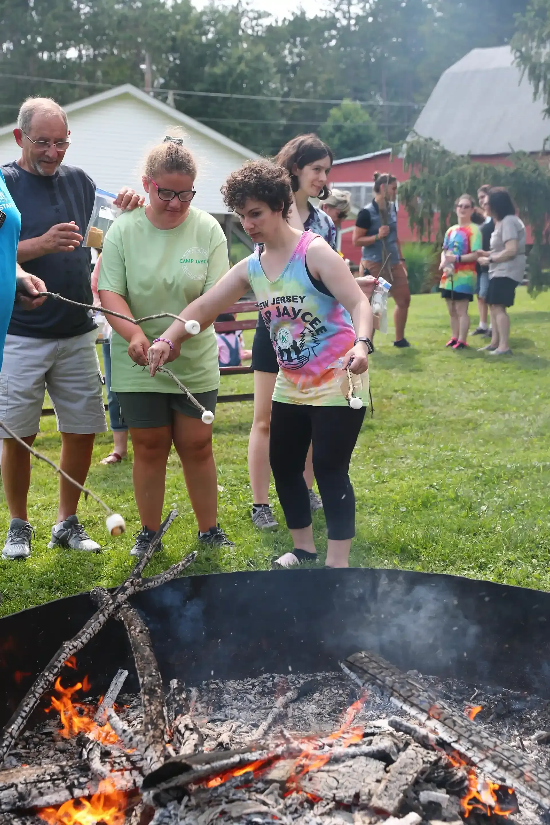 People roasting marshmallows over a campfire outdoors.