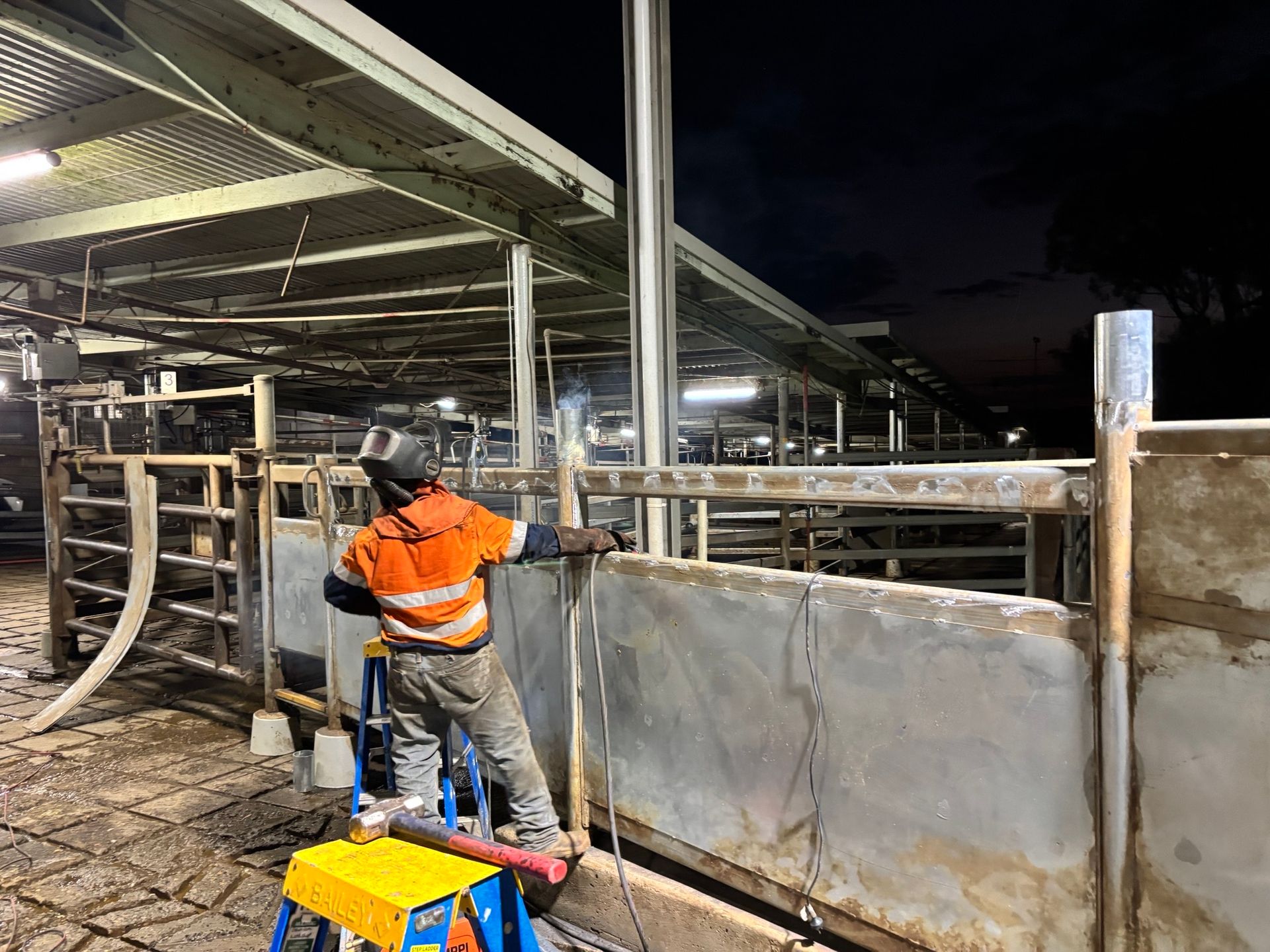 Worker in High Vis Leaning on Work Gate — Harris Engineering Services CQ In Gracemere, QLD.