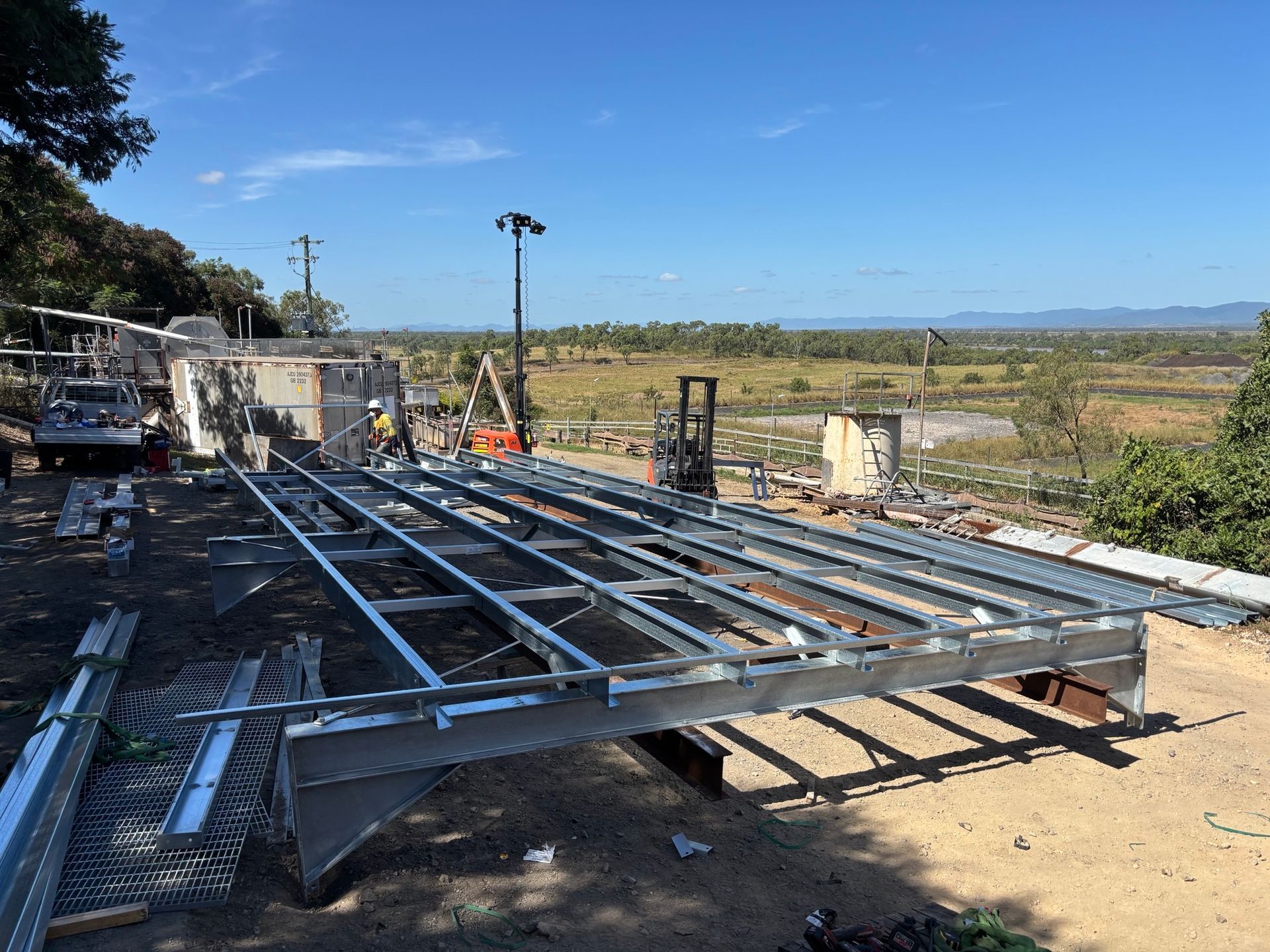 Steel Framework of a Building Under Construction Against a Blue Sky — Harris Engineering Services CQ In Gracemere, QLD