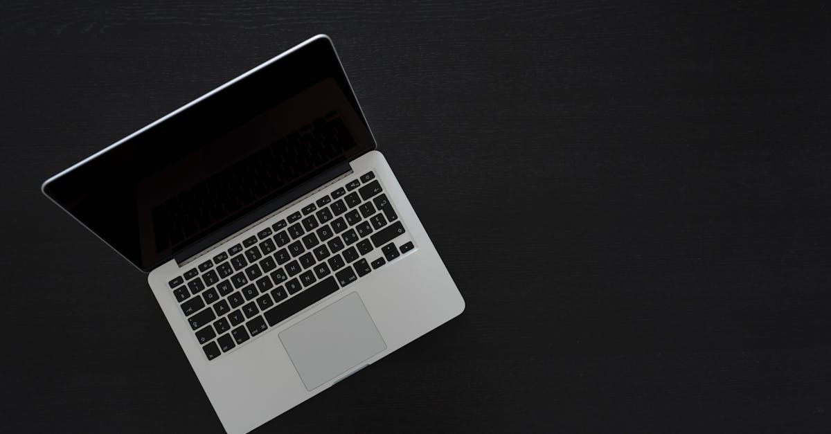 Top-down view of an open silver laptop on a dark background