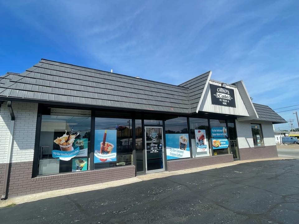 A restaurant with a gray roof and a lot of windows