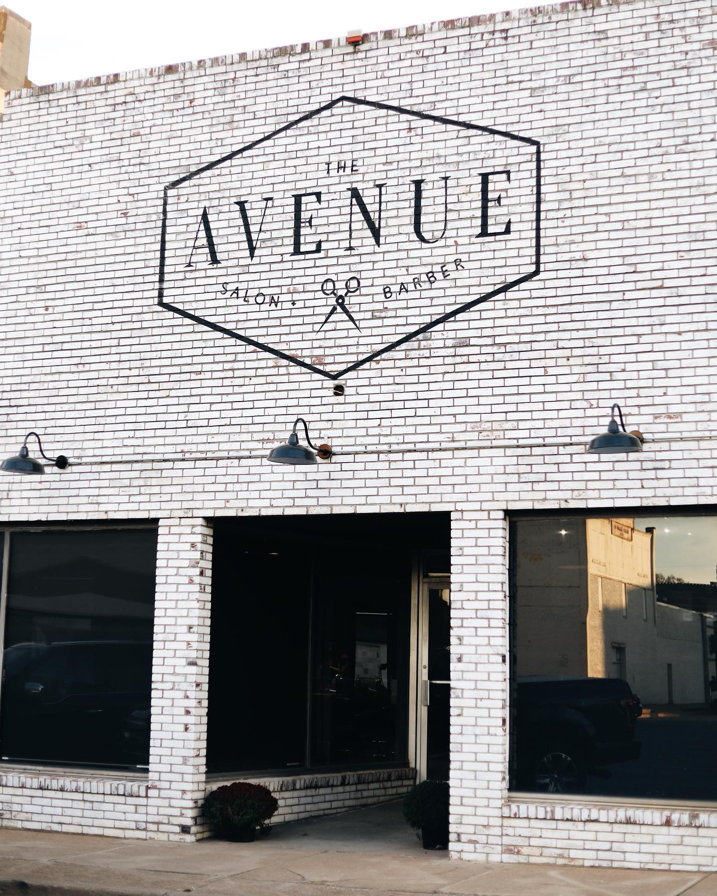 A white brick building with the word avenue painted on it