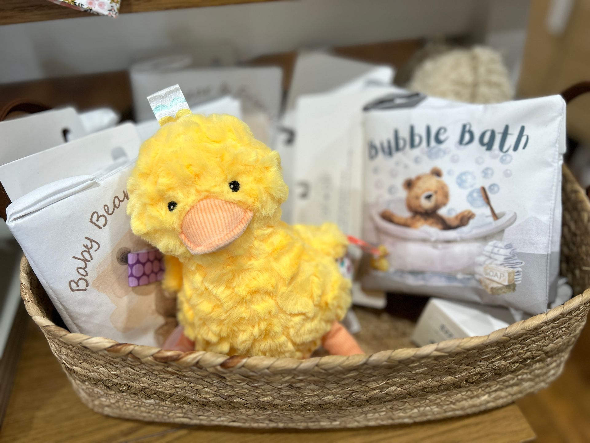 Easter gift basket with a yellow plush chick and bath products in white packaging