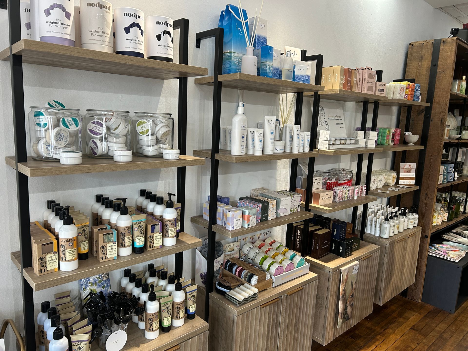 Shelves of assorted packaged goods and jars in a retail shop display