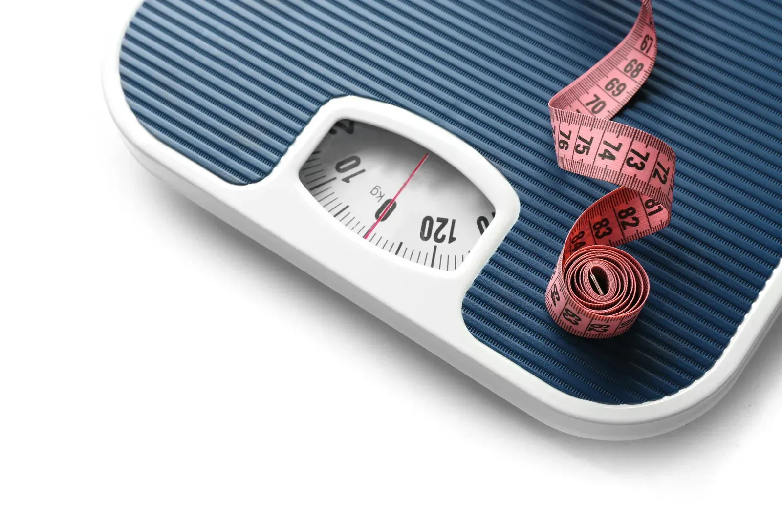 A blue analog bathroom scale with a red measuring tape resting on its surface against a white background.