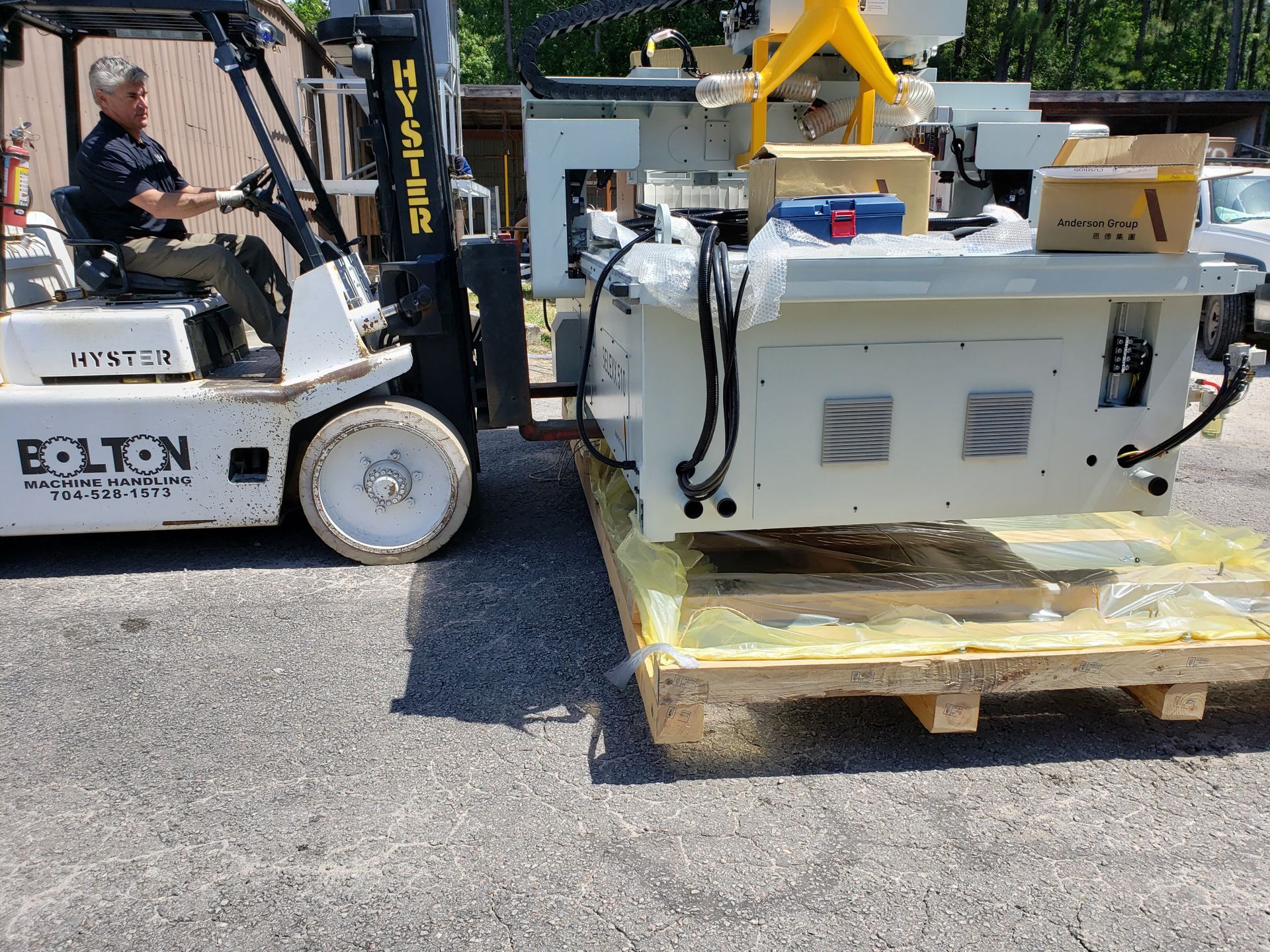 CNC wood router machine being unloaded by forklift during delivery and installation for woodworking automation