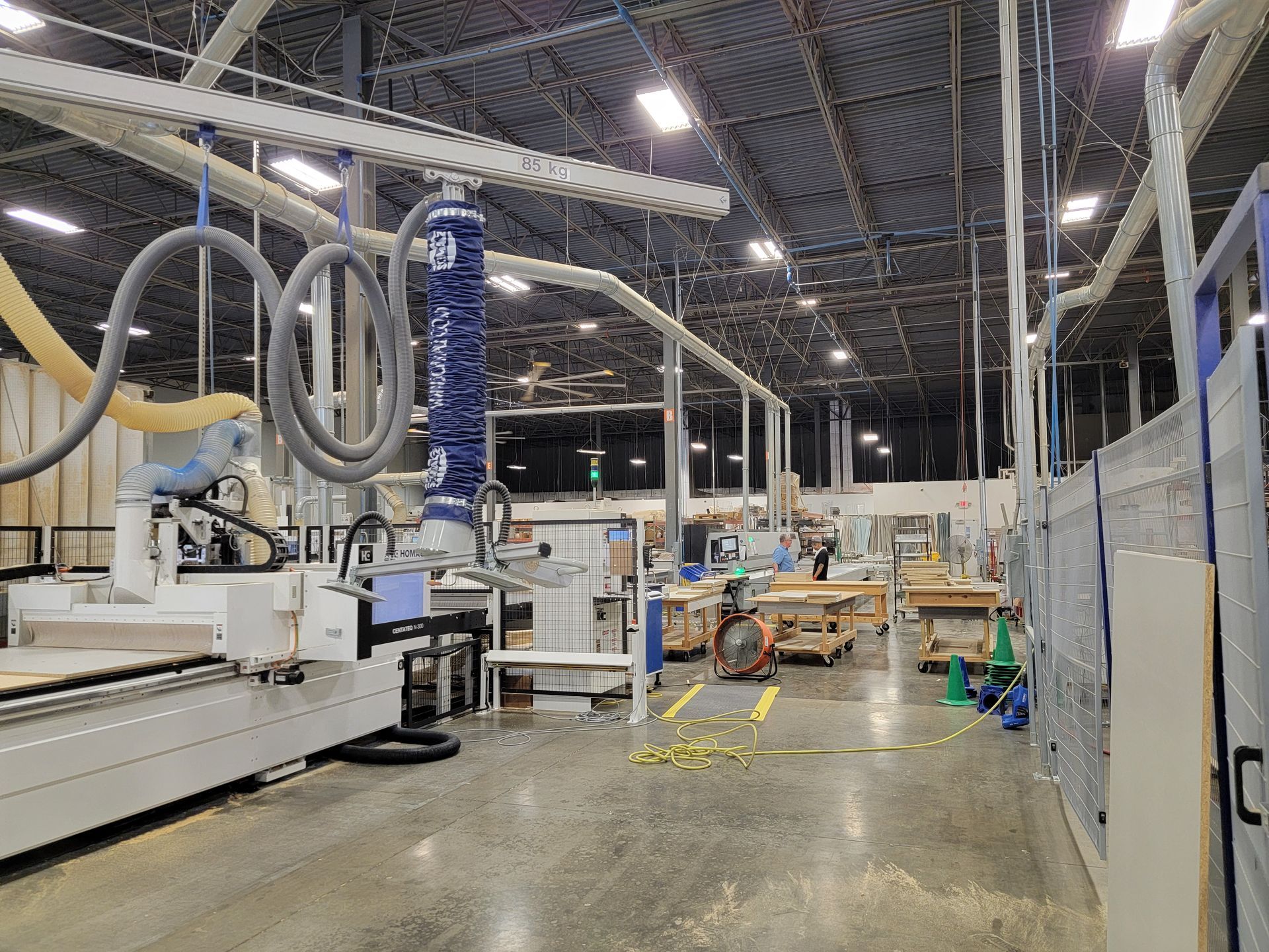 The Closets by Design
warehouse with a lot of machinery in it.