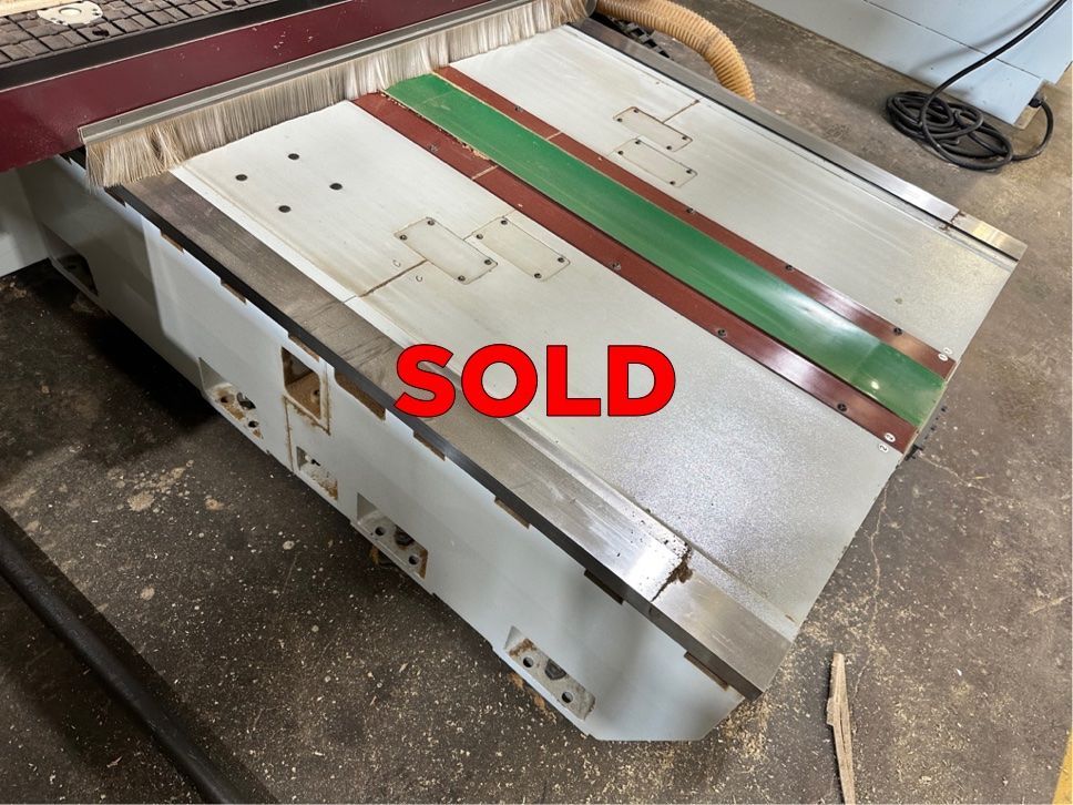 Close-up of a pre-owned CNC router table marked 