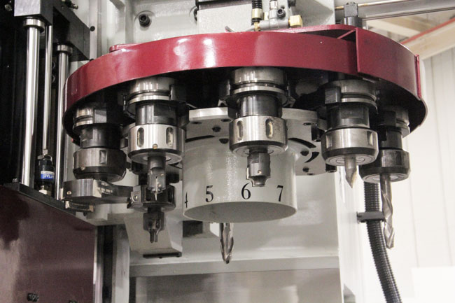 Close-up of a machine tool turret with numbered tool holders.