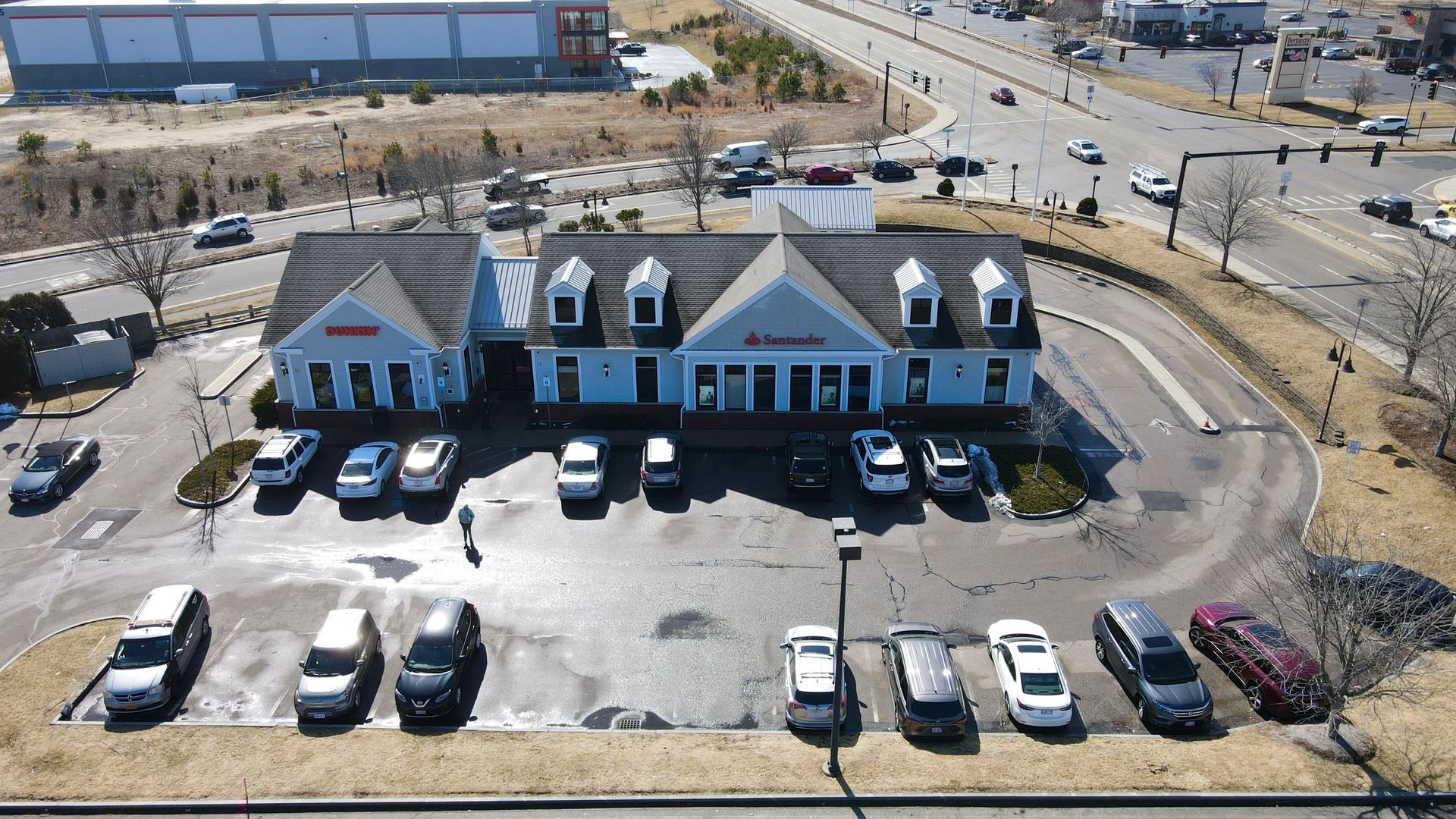 An aerial view of a building with cars parked in front of it