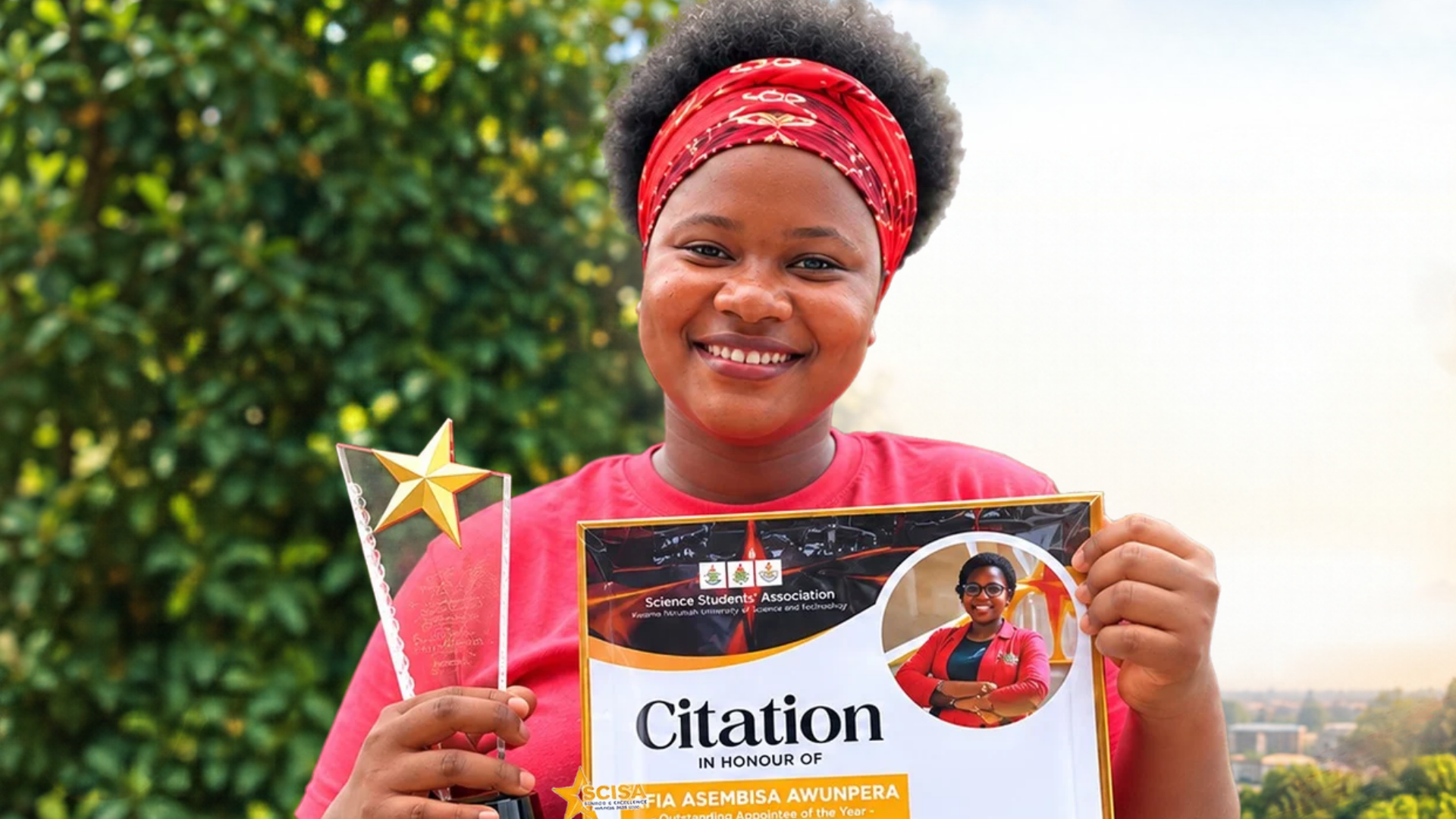 Person holding a citation certificate and star trophy, smiling outdoors