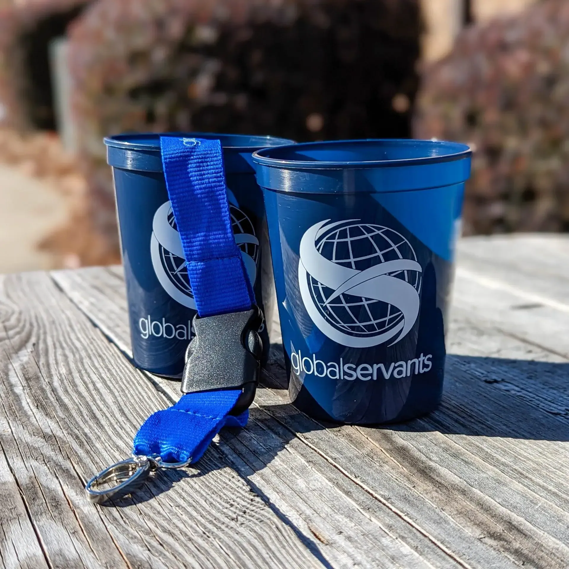 Two blue cups with the word globalservants on them