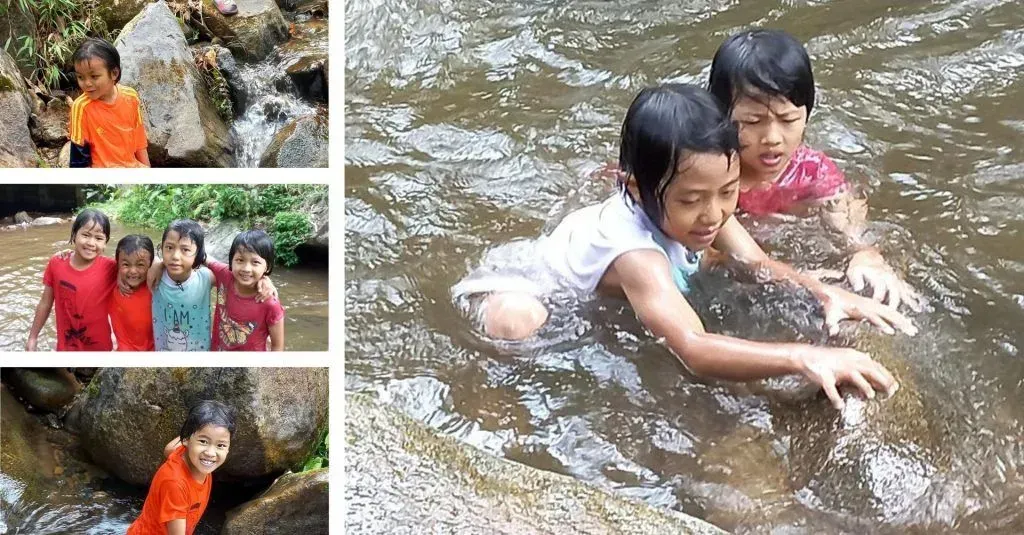 A group of children are playing in a river.