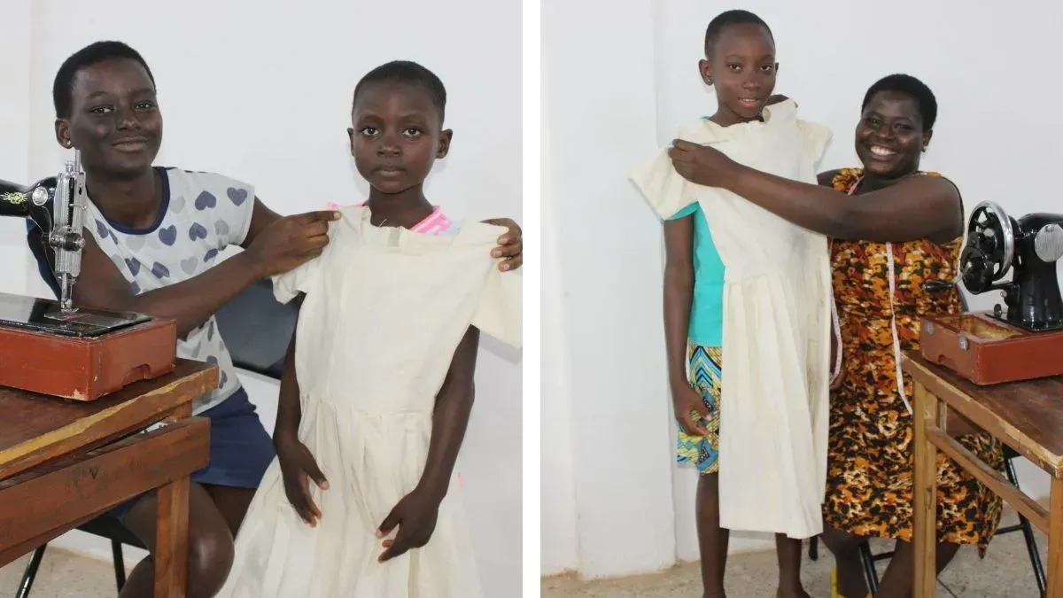 A woman is sewing a dress for a young girl.