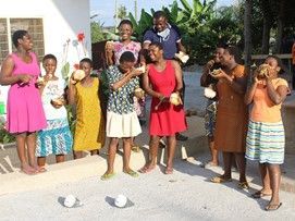 A group of people are standing next to each other playing a game.
