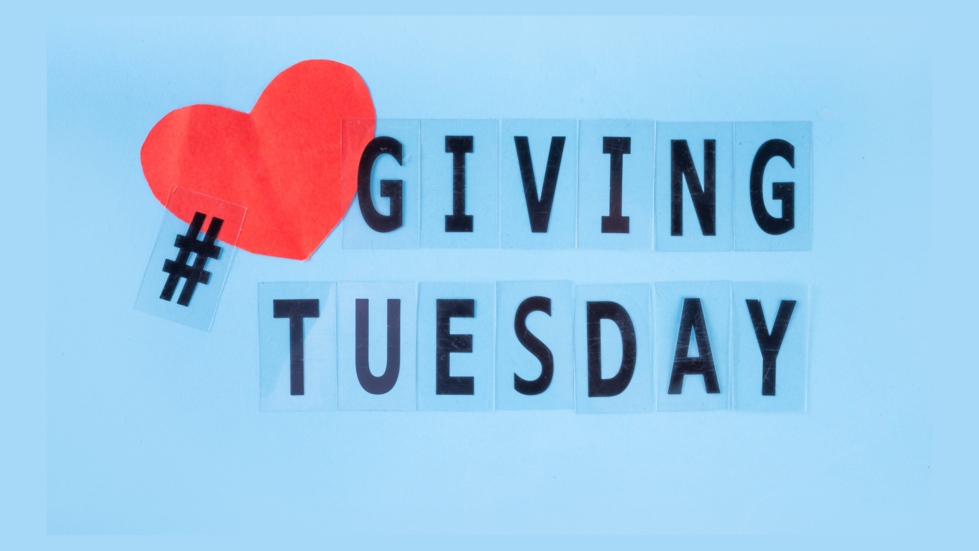 Red heart and hashtag on blue background, spelling GIVING TUESDAY