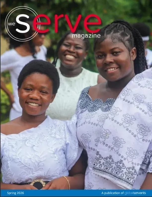 Three smiling people in white dresses on a magazine cover outdoors with the title “Serve Magazine.”