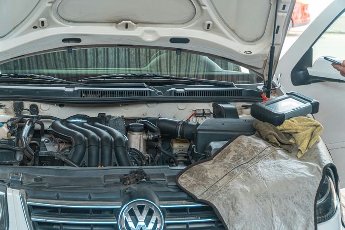 Auto Repair Technician Inspecting Volkswagen Engine | Papillion Auto Service