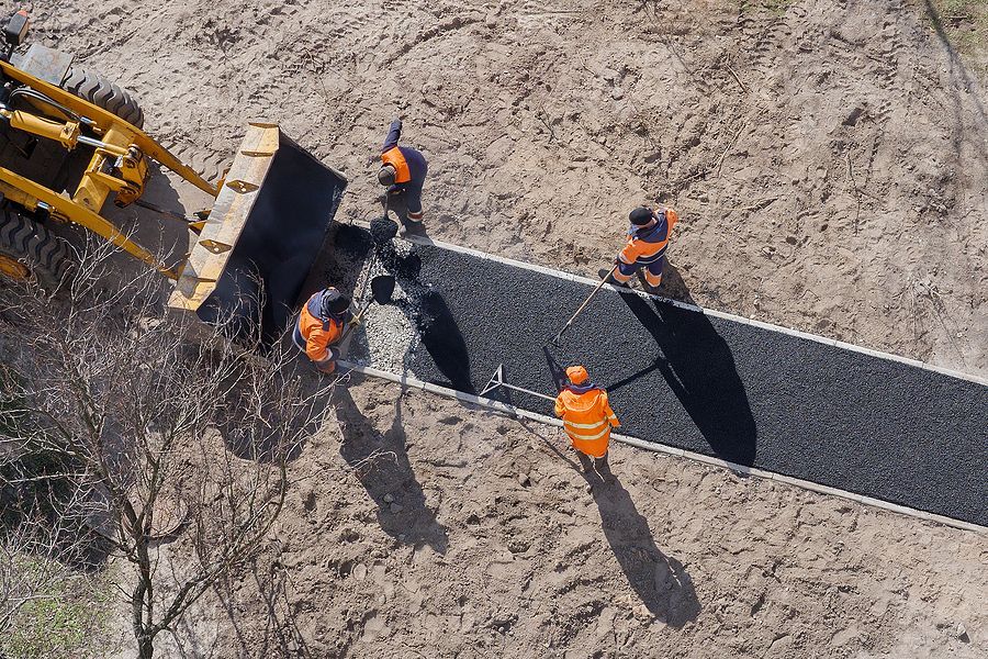 Contractors laying a resin pathway in Cambridge