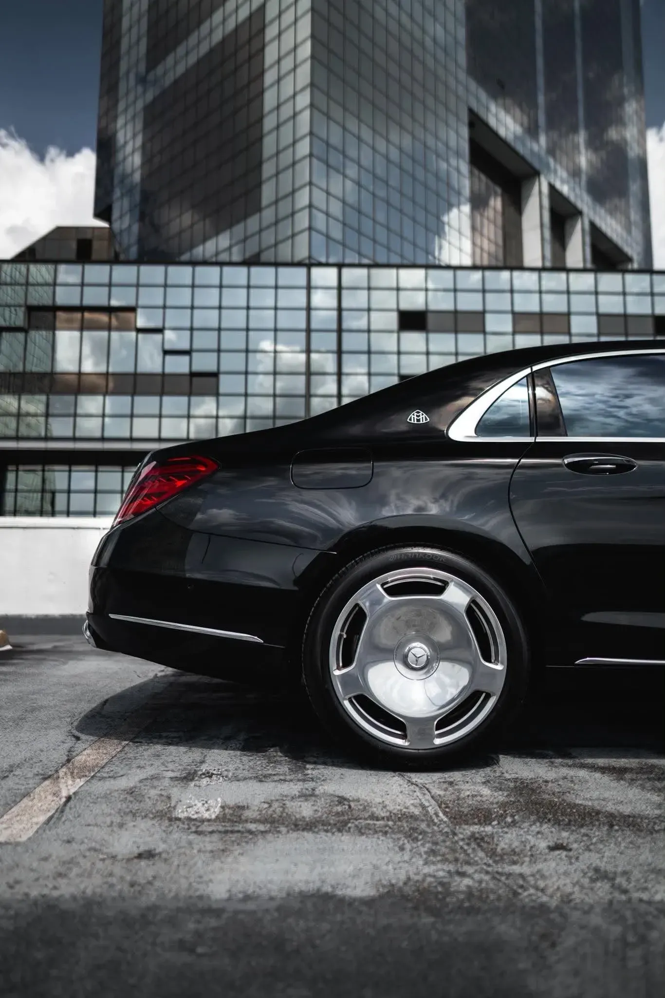 A gleaming black sedan idles at the entrance of The Windsor Court Hotel on Gravier Street