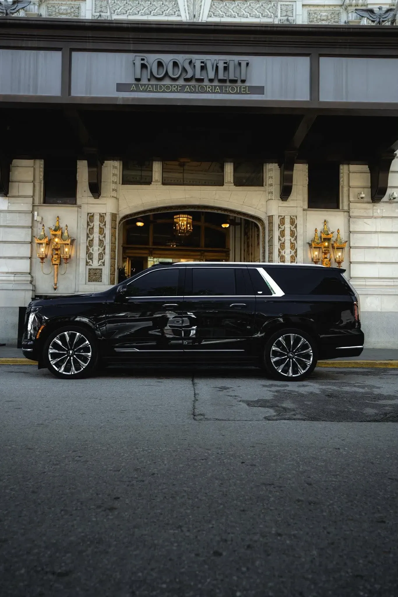 Black Cadillac Escalade — large, dark, unremarkable in the best possible way