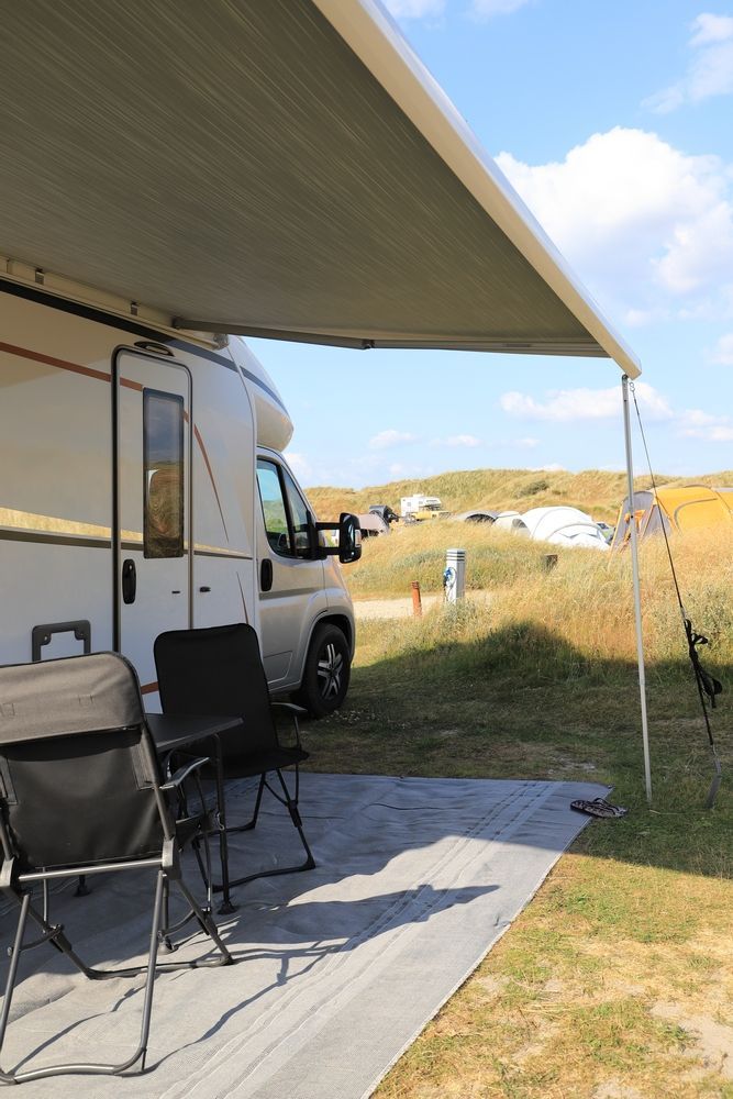 A Caravan Is Parked Under A Canopy In A Field — Kingston Caravan Repairs In Heatherbrae, NSW