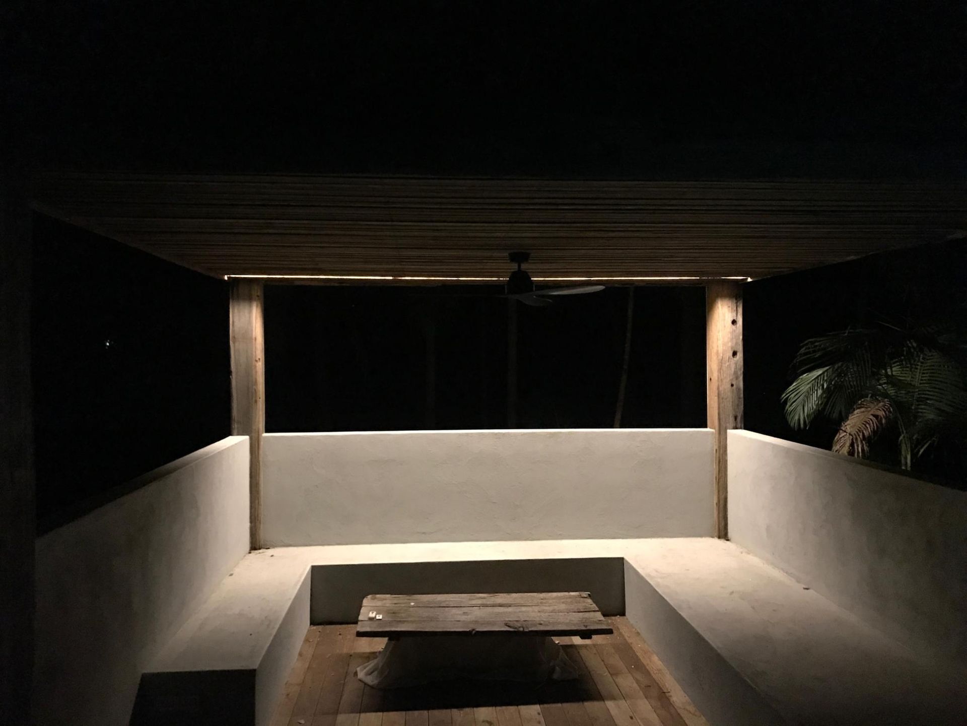 A Dark Room With A Table And A Ceiling Fan — AH Electrical in West Ballina, NSW