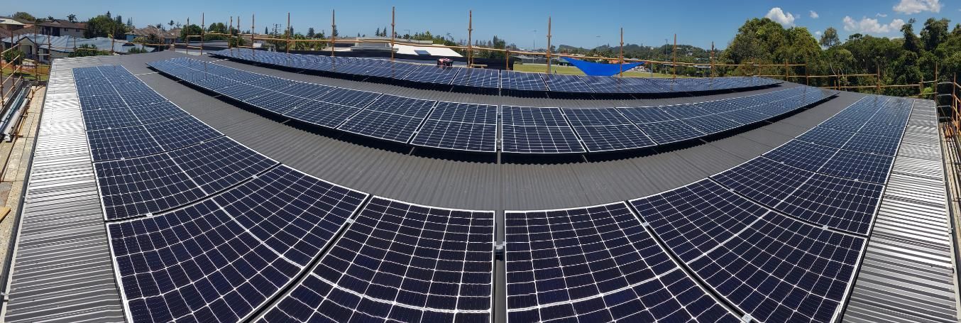 A Large Amount Of Solar Panels Are Sitting On Top Of A Roof — AH Electrical in Wollongbar, NSW