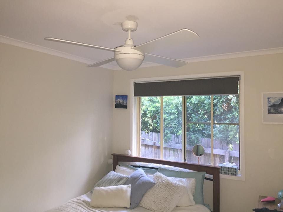 A Bedroom With a Bed and a Ceiling Fan — AH Electrical in West Ballina, NSW