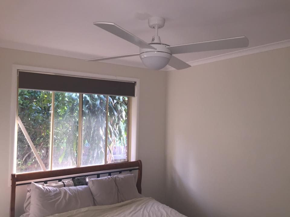 A Bedroom With a Bed and a Ceiling Fan — AH Electrical in West Ballina, NSW